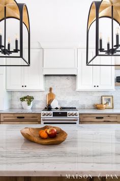 a bowl of fruit sitting on top of a kitchen counter