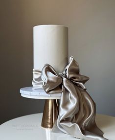 a white cake with a large bow on top