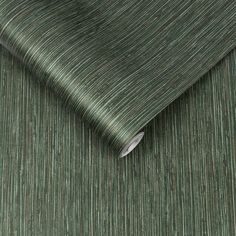 a close up view of a green wallpaper with vertical lines on the fabric,