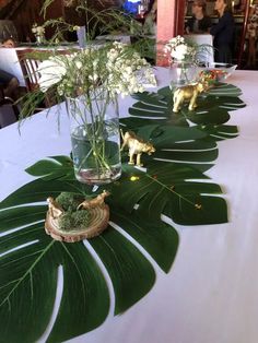 the table is set with plants and animals