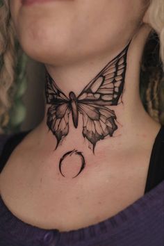 a woman with a butterfly tattoo on her neck