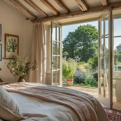 a bed sitting in a bedroom next to an open window with lots of windows on it