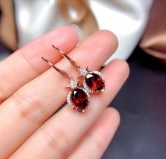 Welcome to Elegant Art Jewelry!  Material: 925 Sterling Silver Stone: Natural Garnet Stone Size: 7mmX9mm Origin: Mozambia Side Stone: Zircon Personalization: 9K/14K/24K/GOLD/SILVER/PLATINUM/ROSE-GOLD/WHITE GOLD. (Contact me)  Garnet Earrings, Garnet Cuff Earrings, Gold Earrings, Gold Stud Earrings, 14k Gold Earrings, 14k Gold Earrings, Round Cut Earrings, Round Cut Stone Earrings, Round Cut Studs Earrings, Garnet Drop Earrings, Garnet Studs Earrings, Garnet Studs, Garnet Earrings, Garnet Dangle Luxury Burgundy Garnet Jewelry, Luxury Garnet Jewelry For Weddings, Elegant Cheap Burgundy Jewelry, Luxury Garnet Earrings As Gift, Luxury Garnet Jewelry For Gifts, Luxury Elegant Garnet Earrings, Luxury Garnet Drop Earrings, Ginny Earrings, Garnet Drop Earrings