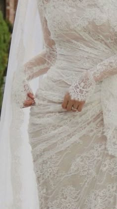 a woman wearing a wedding dress and veil