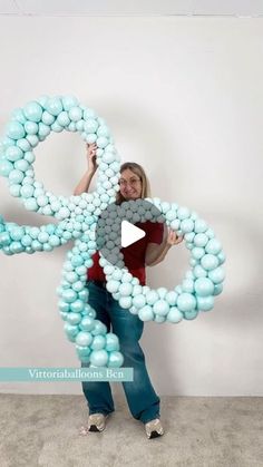 a woman is holding balloons in the shape of an octopus