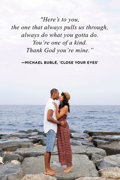 a man and woman kissing on the rocks by the ocean with a quote from frank shanata