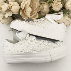 Stunning all white low Converse Platform, faux leather with gold hints, beautifully embellished with : - Fully embellished toe caps and back strips with Pearls and Swarovski crystals - Pearls and Swarovski crystals embellished on the outsides of the shoes in a spray gradual fade effect starting from the front and fading to the back - Finished with Beautiful full satin laces Available with all 4 sides of the shoe embellished with pearls or just the outsides of the shoes embellished (2 sides) (This photo shows 2 sides) Platform Converse Wedding, White Low Converse, Pearl Converse, Low Converse, Converse Wedding, Bridal Converse, Converse Custom, Converse Platform, Wedding Converse