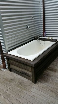 a bath tub sitting on top of a wooden floor