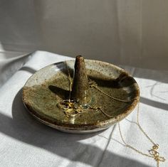 a plate with a tree on it sitting on top of a white cloth covered table