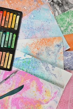 an artist's palette with crayons and watercolors