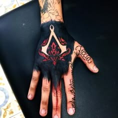 a person's hand covered in black and red ink with the letter y on it