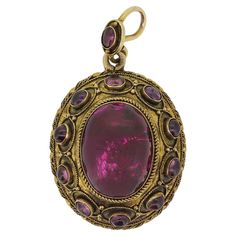 This is an antique 15ct yellow gold oval locket pendant. The pendant was wonderfully handcrafted in the mid Victorian era and shows a high level of workmanship that is near impossible to replicate in modern jewellery. It is crafted in an Etruscan revival style and the garnets have a well matched lovely purple tone. It has a compartment on the back that currently features the original owners loved ones hair but this can easily be replaced. Condition: Used (Very Good) Weight: 9.0 grams Dimensions: Victorian Locket, Purple Tone, Oval Locket, Modern Jewellery, Pendent Necklace, One Hair, Visual Diary, Antique Jewellery, Locket Necklace