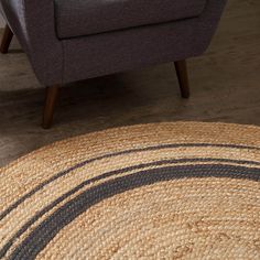 a living room with a chair and rug on the floor