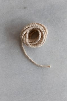 a spool of twine on a white surface