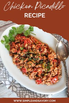 chicken picadillo recipe on a white plate with a spoon and napkin next to it