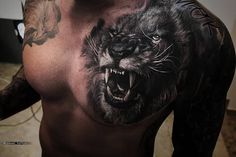 a man with a wolf tattoo on his chest