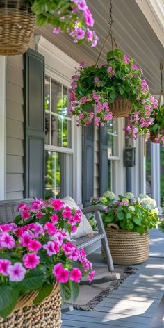 hanging baskets filled with flowers on the front porch