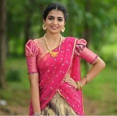 a woman in a pink sari posing for the camera