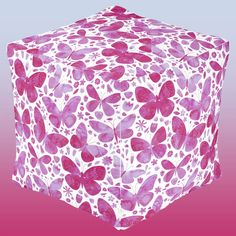 a pink and white cube with purple butterflies on it