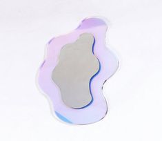 a mirror that is sitting on top of a white surface with a reflection in it