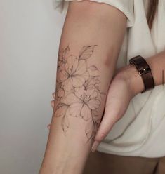 a woman with a flower tattoo on her arm