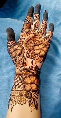 a woman's hand is decorated with hennap and intricate designs on it