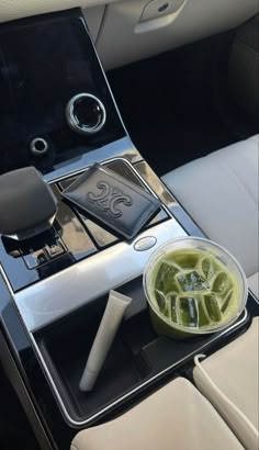 the interior of a car with a drink tray and cup holder