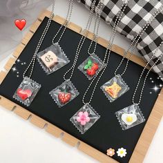 the necklaces are decorated with different types of candies and fruits on them,