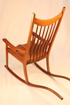 a wooden rocking chair on a white background