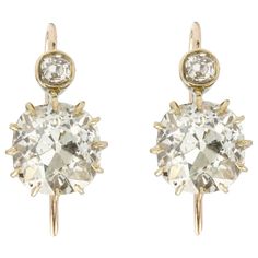 An antique pair of old-cut diamond drop earrings, each earring with a large old mine-cut diamond, the one weighing 2.87 carats of M colour and VS1 clarity, the other weighing 2.91 carats of M colour and SI2 clarity, both accompanied by GCS Report, each suspended by a small old-cut diamond estimated to weigh 0.15 carats, mounted in yellow gold with continental hook fittings, circa 1900, measuring approximately 1.7 x 0.9cm, gross weight 4.7 grams. This antique pair of earrings is in excellent cond Her Majesty The Queen, Diamond Drops, Diamond Drop Earrings, Bentley, Leather Case, Leather Handmade, Bracelet Watch, Diamond Earrings, Diamond Cuts