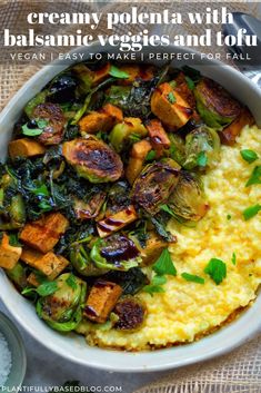 a white bowl filled with mashed potatoes and veggies on top of grits