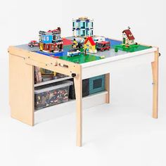 a wooden table with legos on top and drawers underneath it, in front of a white background