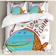 a bed with an image of a fish on it's cover and pillow cases