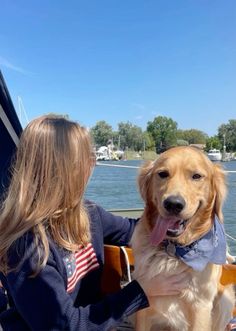 a woman sitting on a boat with her dog