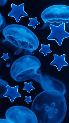 blue jellyfish are floating in the water