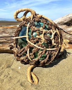 there is a ball made out of rope on the beach