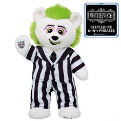 a white and green stuffed animal wearing a referee outfit