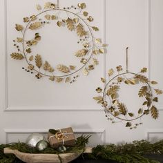 two metal wreaths are hanging on the wall