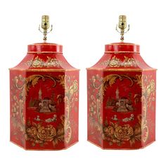 two red and gold vases sitting next to each other