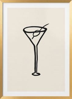 a black and white drawing of a martini in a gold frame on the wall above it