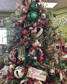 a christmas tree decorated with ornaments and ribbons