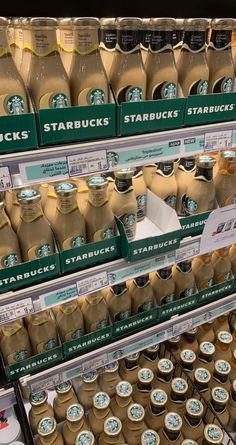 there are many bottles of starbucks coffee on display