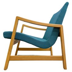 a wooden chair with blue upholstered fabric