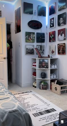 a bedroom with pictures on the wall and a bar code sign hanging from the ceiling