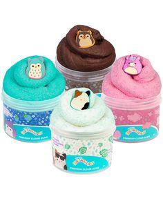 three cupcakes in plastic containers with animals on the top and one has an owl