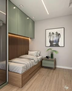 a bedroom with wood flooring and green cabinetry on the wall above the bed