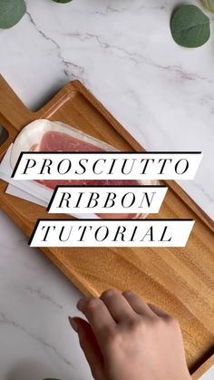 someone cutting meat on a wooden cutting board with the words prosciutto ribbon