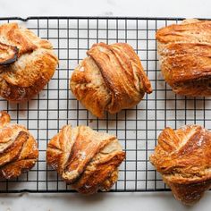 freshly baked croissants on a cooling rack ready to be eaten for breakfast