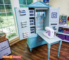 a sewing machine sitting on top of a wooden table next to a blue cabinet filled with craft supplies