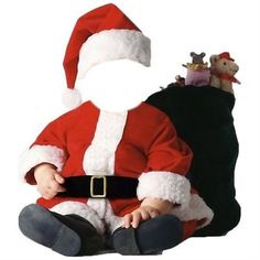 a baby dressed as santa clause sitting next to a stuffed animal on a white background